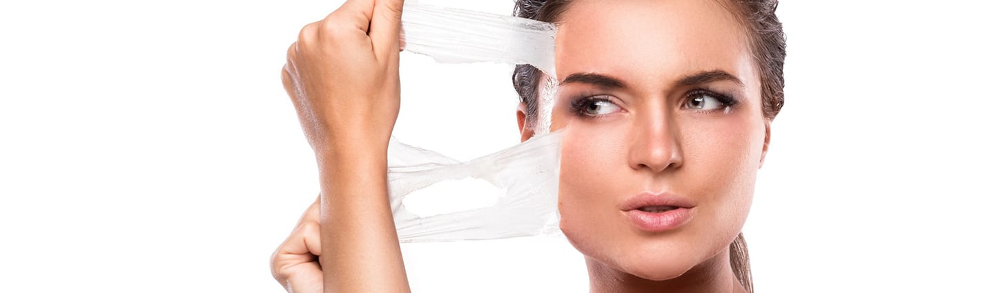 Professional aesthetician applying chemical peel treatment to patient in modern Scottsdale spa facility