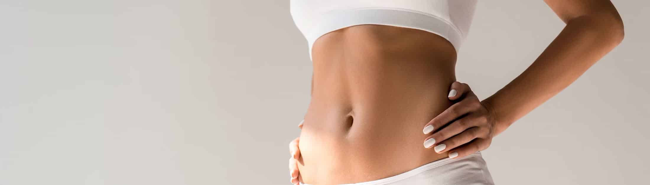 Dr. William Hall performing liposuction consultation in modern Scottsdale clinic
